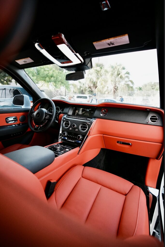 A car with red leather seats and black trim.