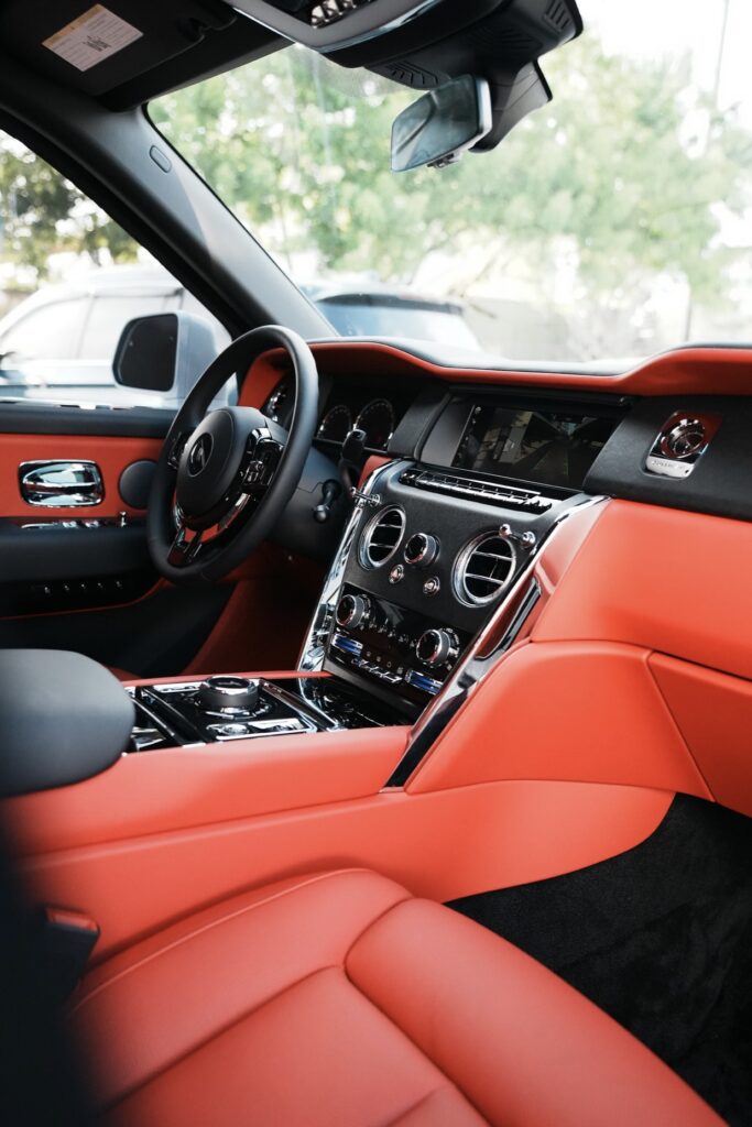 A car with red leather seats and steering wheel.