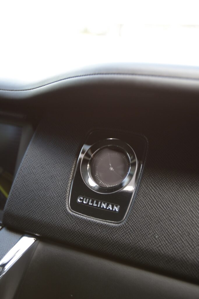 A close up of the interior of a car with a button on it.